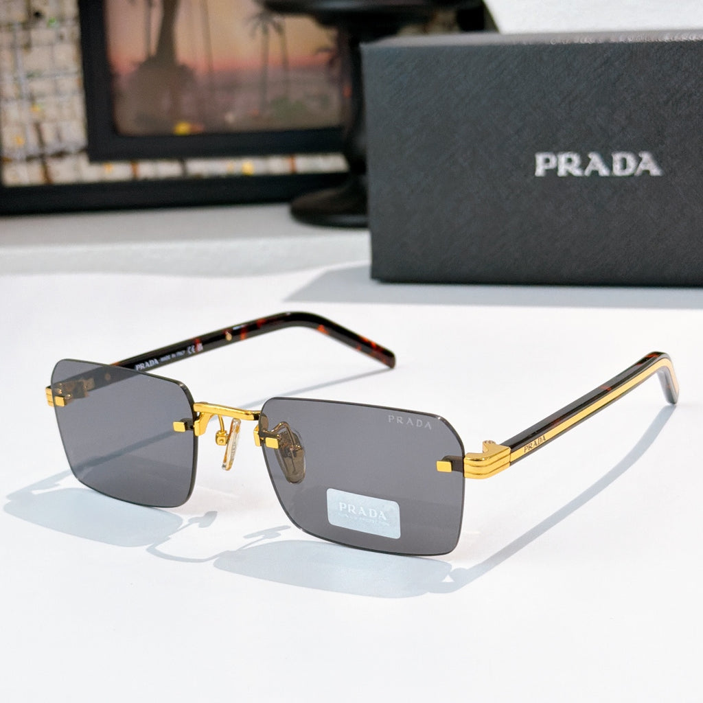 Prada eyeglasses with dark lenses, gold frame detailing, and tortoiseshell temple arms