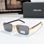 Prada eyeglasses with dark lenses, gold frame detailing, and tortoiseshell temple arms