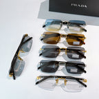 Prada eyeglasses set on display with blue, amber, and dark lens options