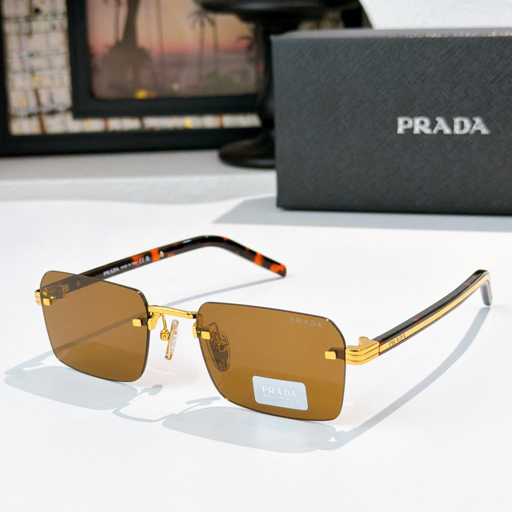 Prada eyeglasses with amber lenses, gold frame, and tortoiseshell temple tips
