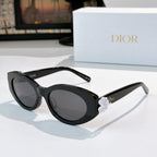 Black Dior sunglasses with oval lenses and white floral detail on the temple.