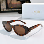 Tortoiseshell Dior sunglasses with round lenses and dark gradient tint.