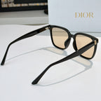 Cat-eye sunglasses angled view with beige lenses, black frame and gold stud hinge detail