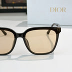 Cat-eye sunglasses side view with beige-tinted lenses, black frame and gold hinge detail