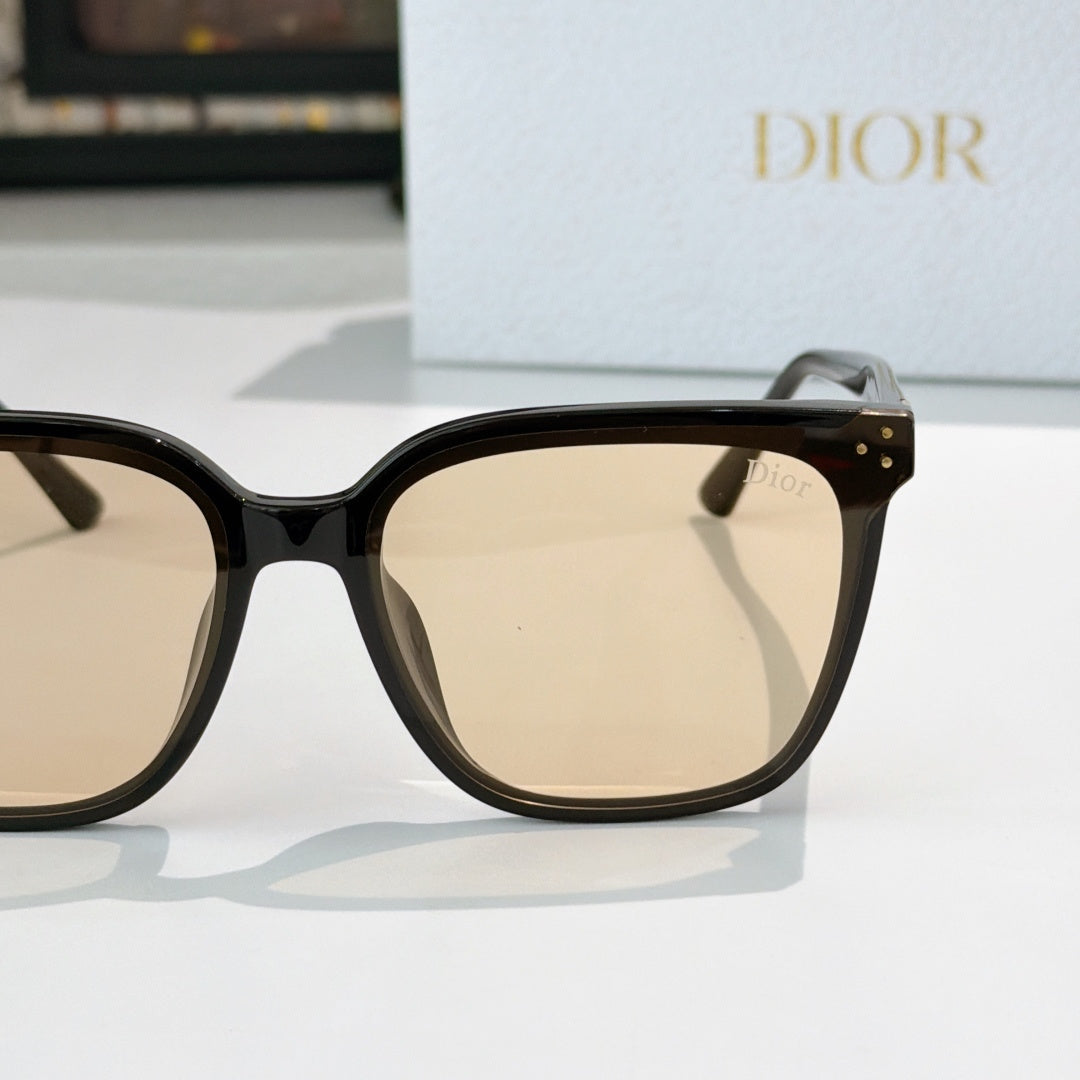 Cat-eye sunglasses side view with beige-tinted lenses, black frame and gold hinge detail