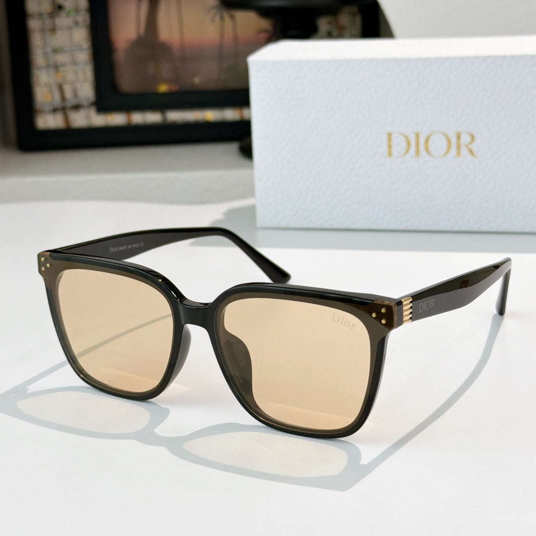 Cat-eye sunglasses with beige lenses and black frame, gold stud accents