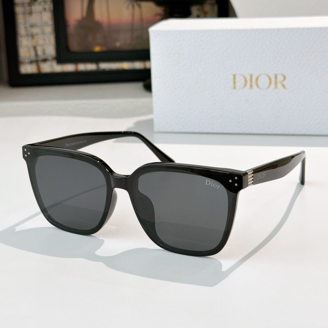 Cat-eye sunglasses with dark lenses and glossy black frame, gold logo details
