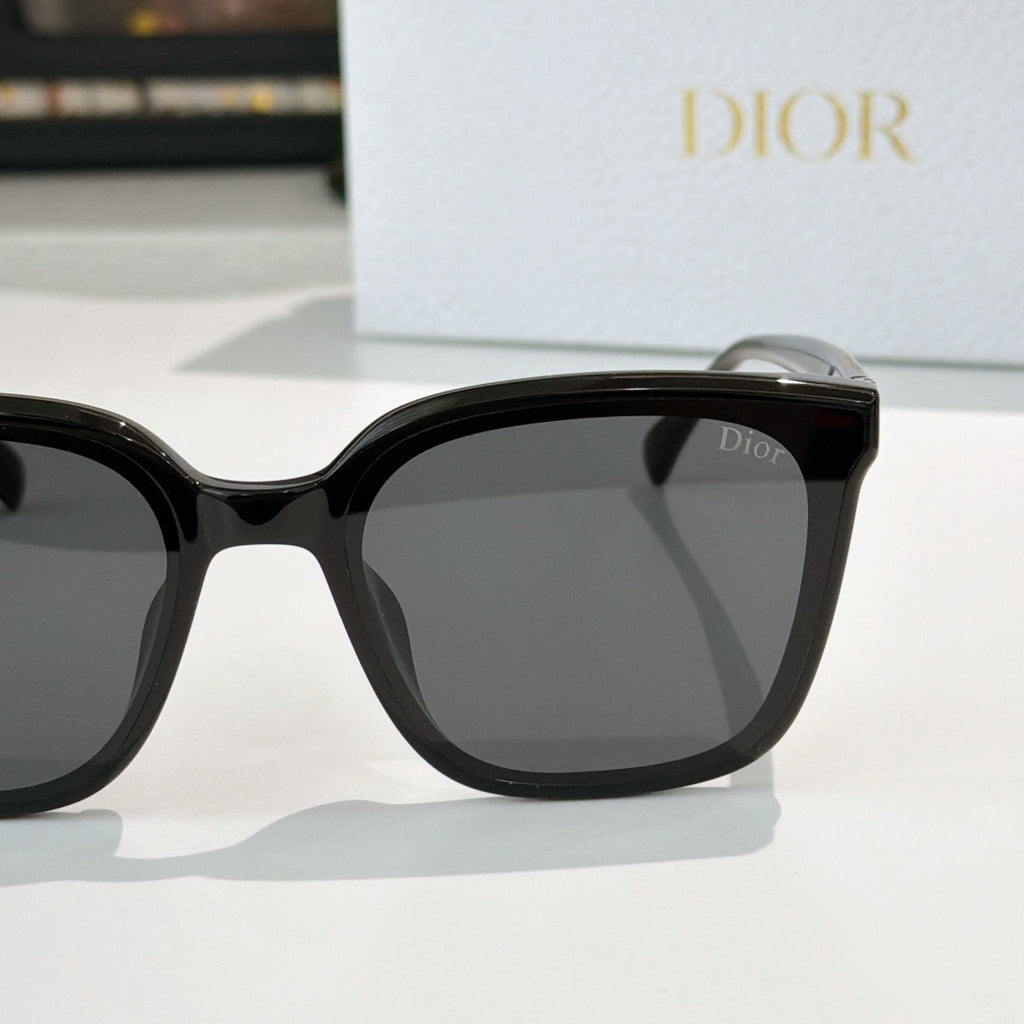 Dior sunglasses, black cat-eye frame with dark lenses and gold-tone temple detail