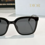 Dior sunglasses, black cat-eye frame with dark lenses and gold-tone temple detail
