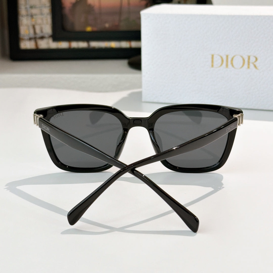 Dior sunglasses, black cat-eye frame with dark lenses and gold-tone hinge