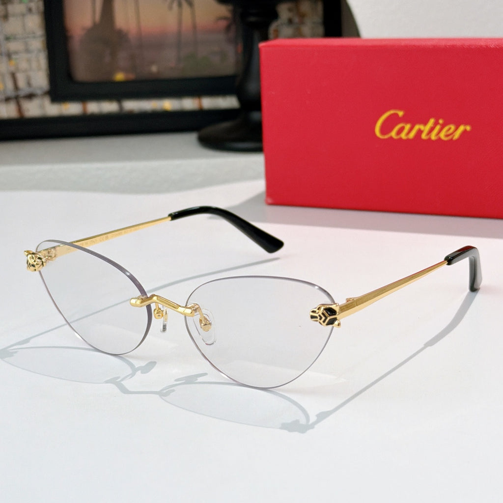 Gold-tone sunglasses with clear lenses and black temple tips, slim cat-eye frame
