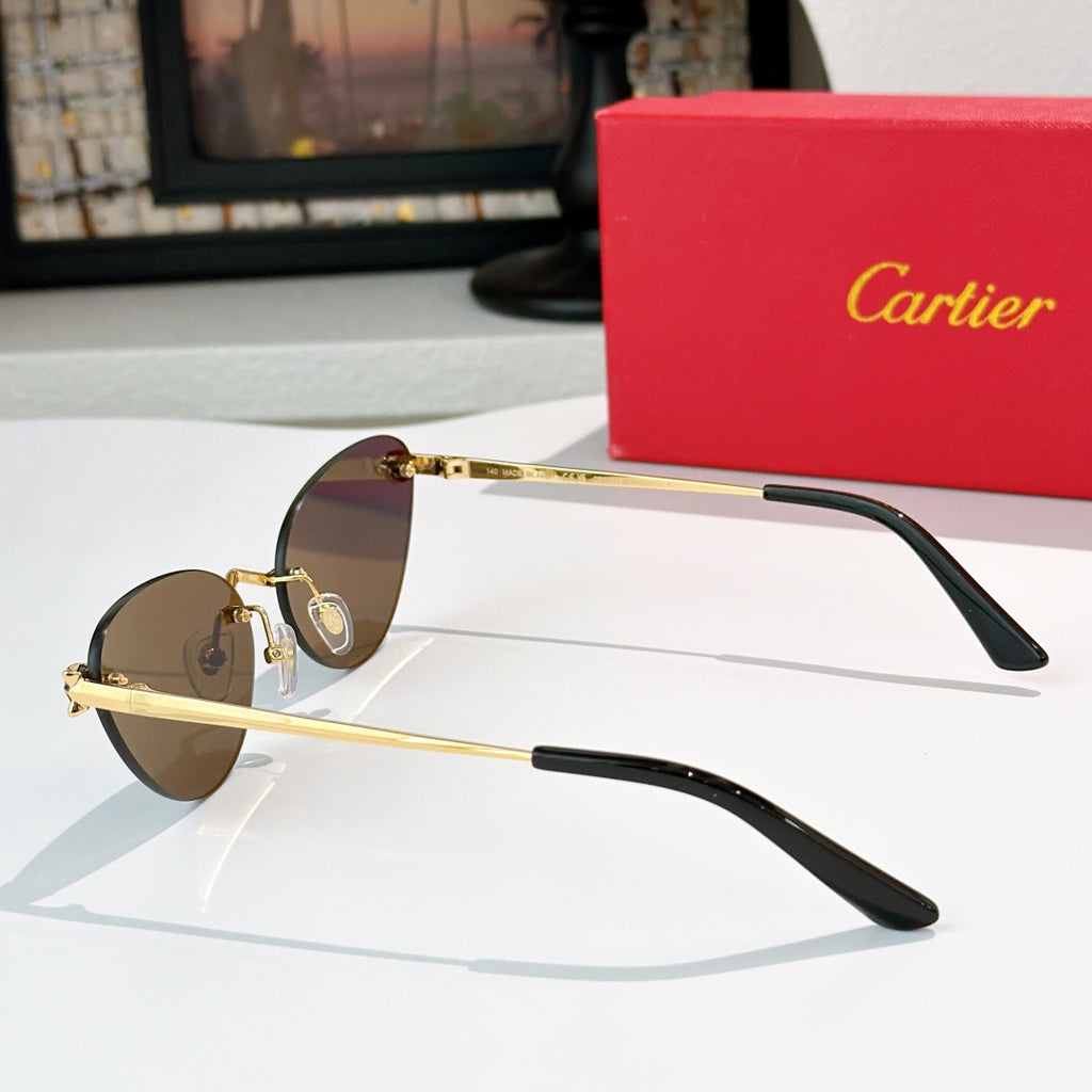 Gold-tone sunglasses with brown lenses and black temple tips, thin round cat-eye frame