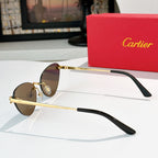 Gold-tone sunglasses with brown lenses and black temple tips, thin round cat-eye frame