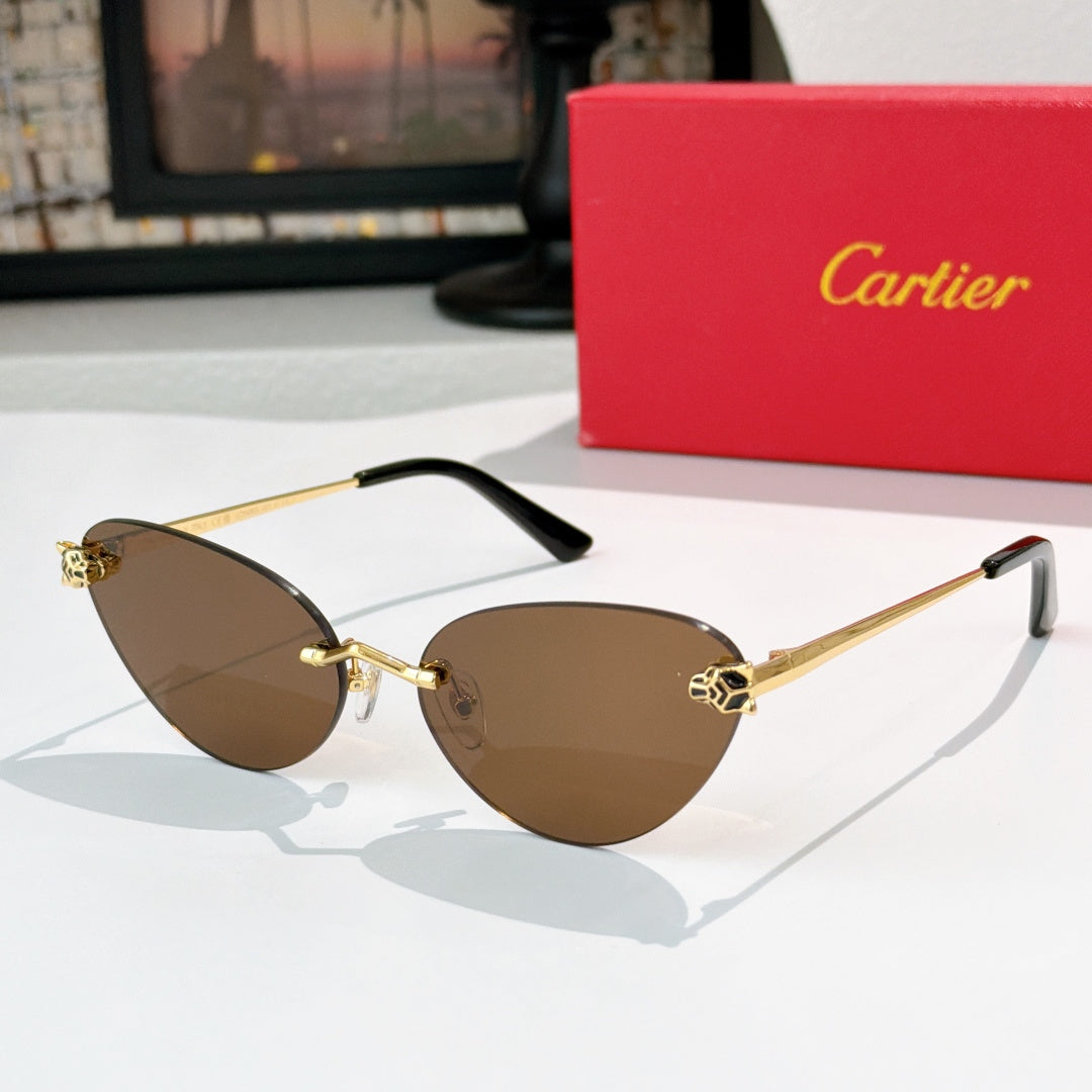 Gold-tone sunglasses with brown-tinted lenses and black temple tips, slim cat-eye frame