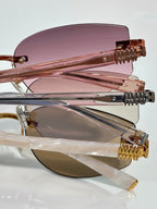 MiuMiu glasses close-up: rose-tinted lenses with gold metal hinge and frame detail