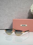 MiuMiu glasses with gradient tinted lenses and slim metal frame with gold temple tips