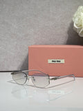 MiuMiu glasses with clear lenses, thin dark frame, and gold logo on the temple