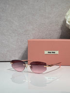 MiuMiu glasses with rose-tinted lenses and thin metal frame, gold temple accents