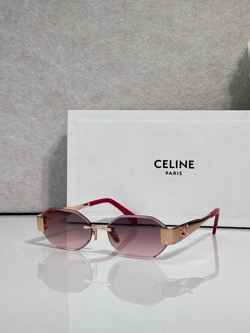 Celine oval sunglasses with red arms and mauve-tinted lenses