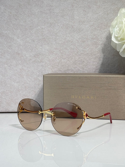Gold-rim round sunglasses with dark brown gradient lenses and thin metal arms.