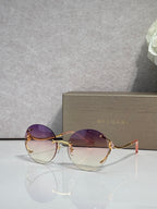 Gold-rim round sunglasses with purple gradient lenses and slim metal temples.