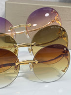 Gold-rim round sunglasses with overlapping purple and amber tinted lenses.