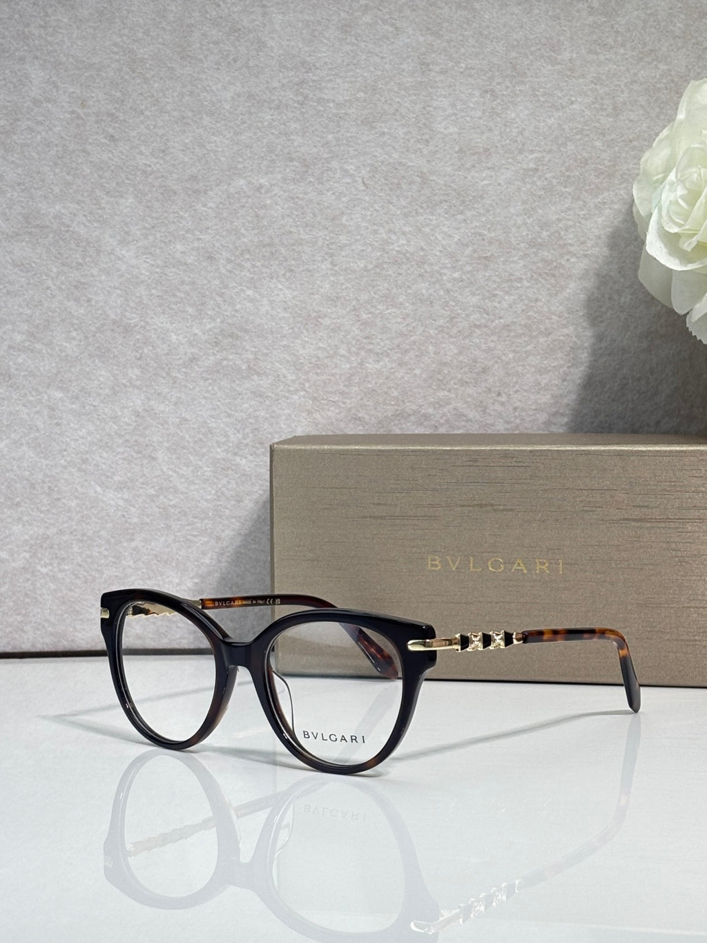 Bvlgari eyeglasses with dark blue round frame and gold temple accents