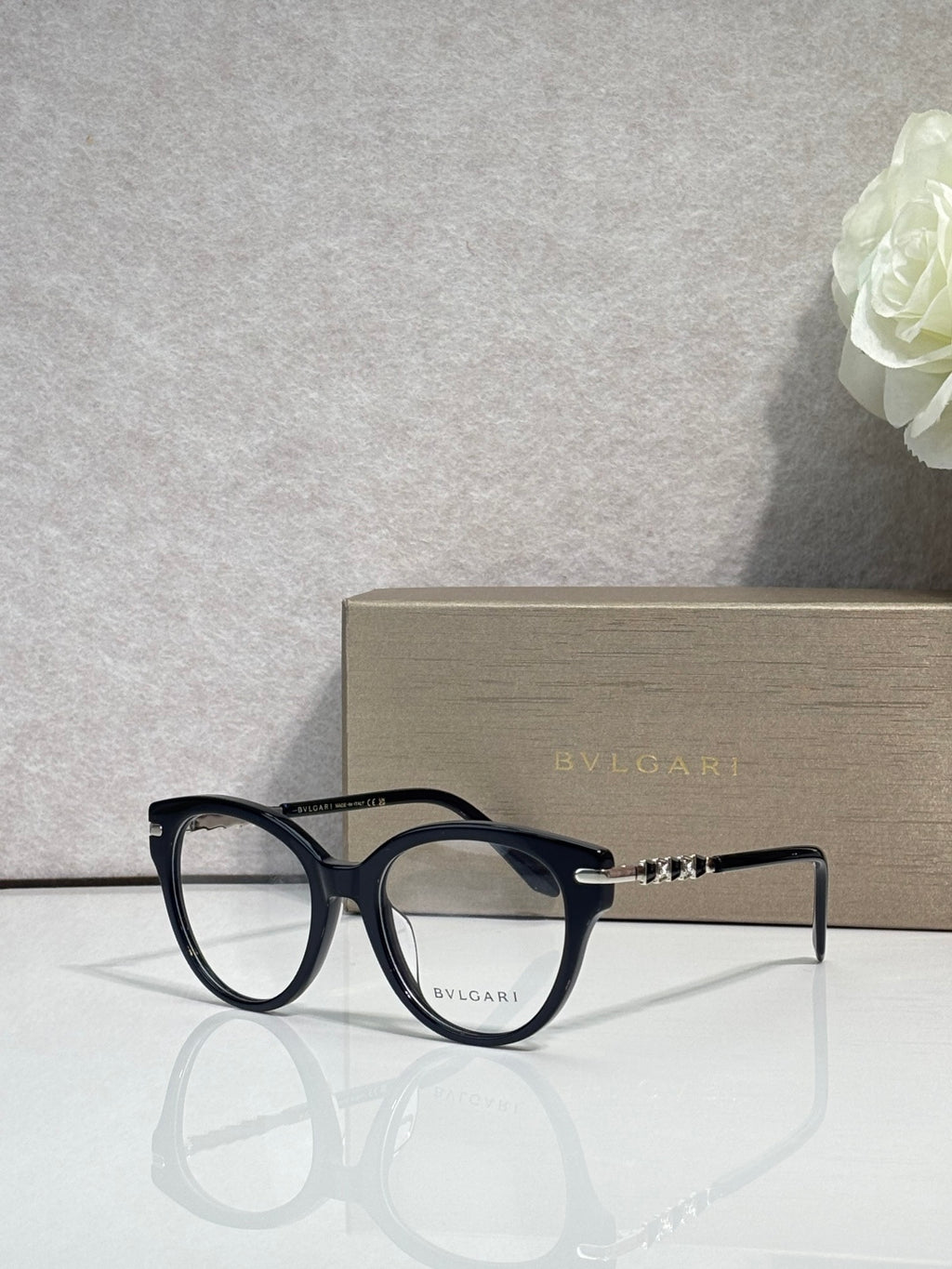 Bvlgari eyeglasses with black round frame and gold temple accents