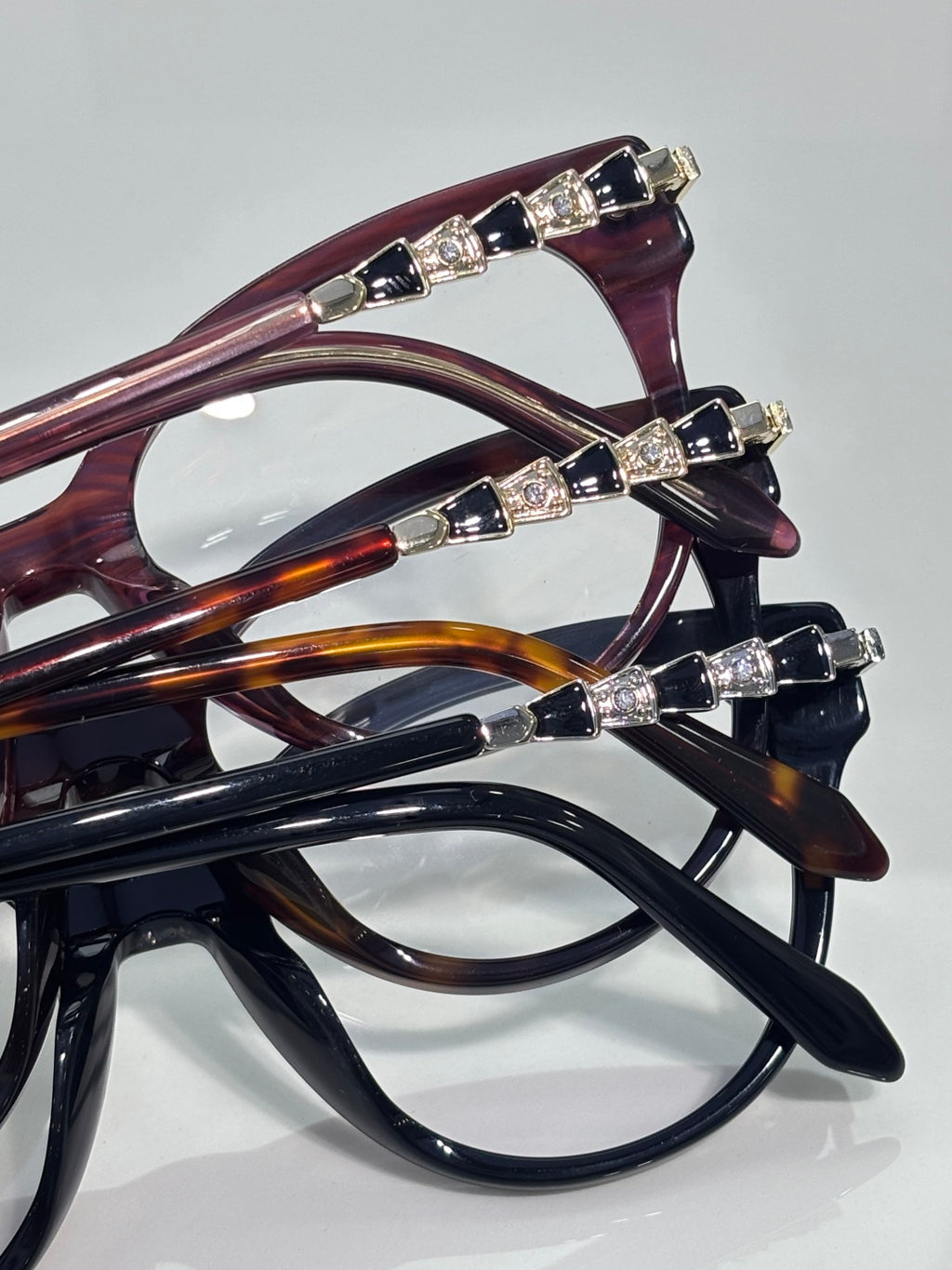 Bvlgari eyeglasses close-up: multiple frames with gold jeweled temple accents
