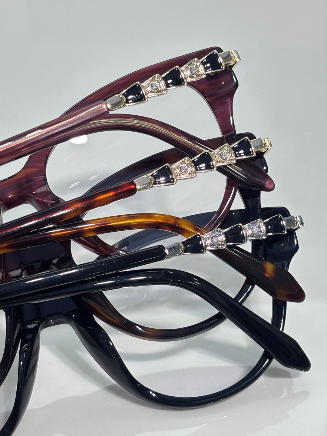 Bvlgari eyeglasses close-up: multiple frames with gold jeweled temple accents