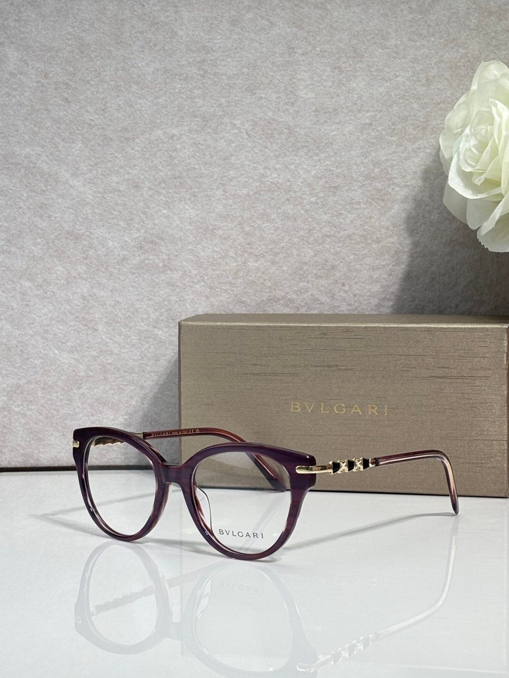 Bvlgari eyeglasses with burgundy round frame and gold temple detail