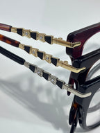 Bvlgari eyeglasses close-up: gold temple hinges with small jeweled studs