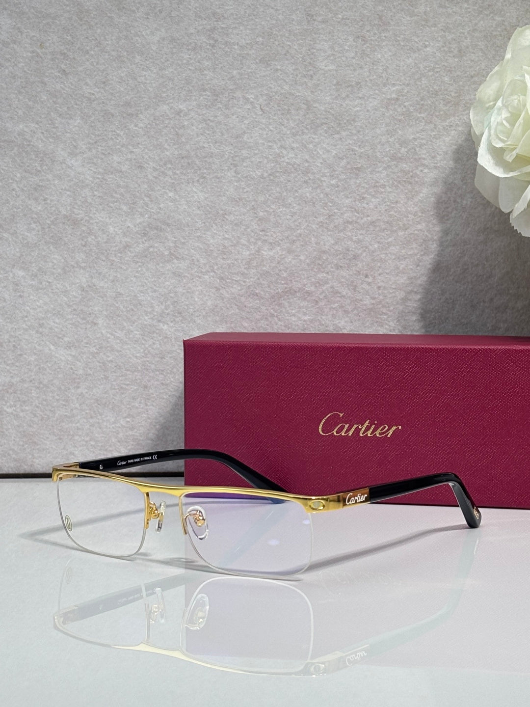 Cartier eyeglasses with dark frame and gold arms, clear lenses and logo