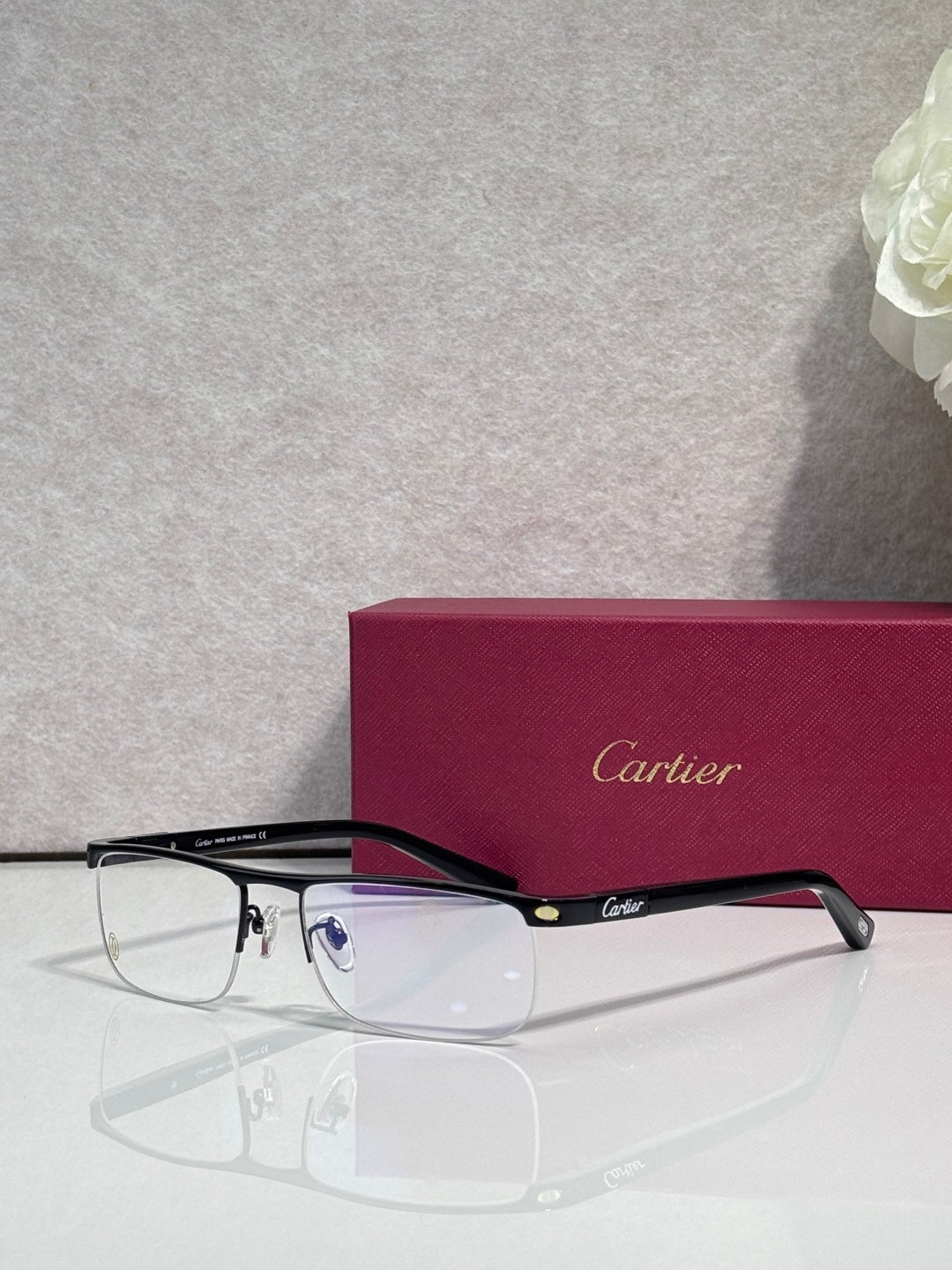 Cartier eyeglasses with dark frames and clear lenses, shown side profile