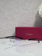 Cartier eyeglasses with dark frames, clear lenses, and gold bridge detail