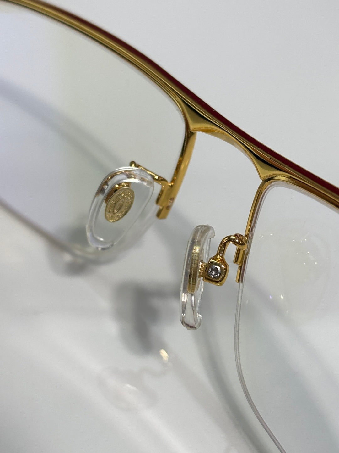 Cartier eyeglasses close-up of gold frame rim and clear lens