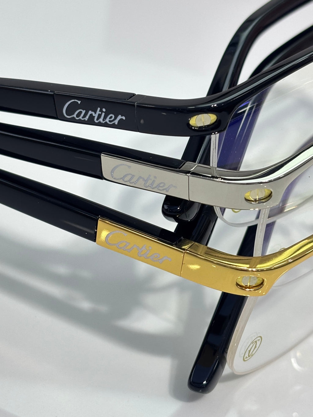 Cartier eyeglasses close-up of dark temples with gold hinges and logo