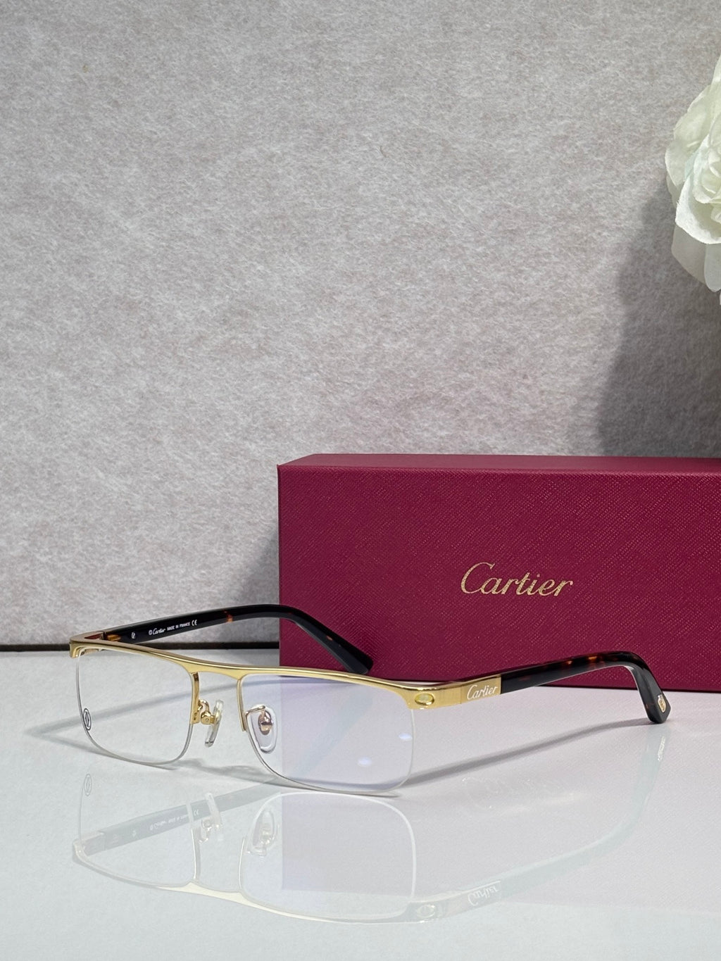 Cartier eyeglasses with dark frame and gold arms, clear lenses