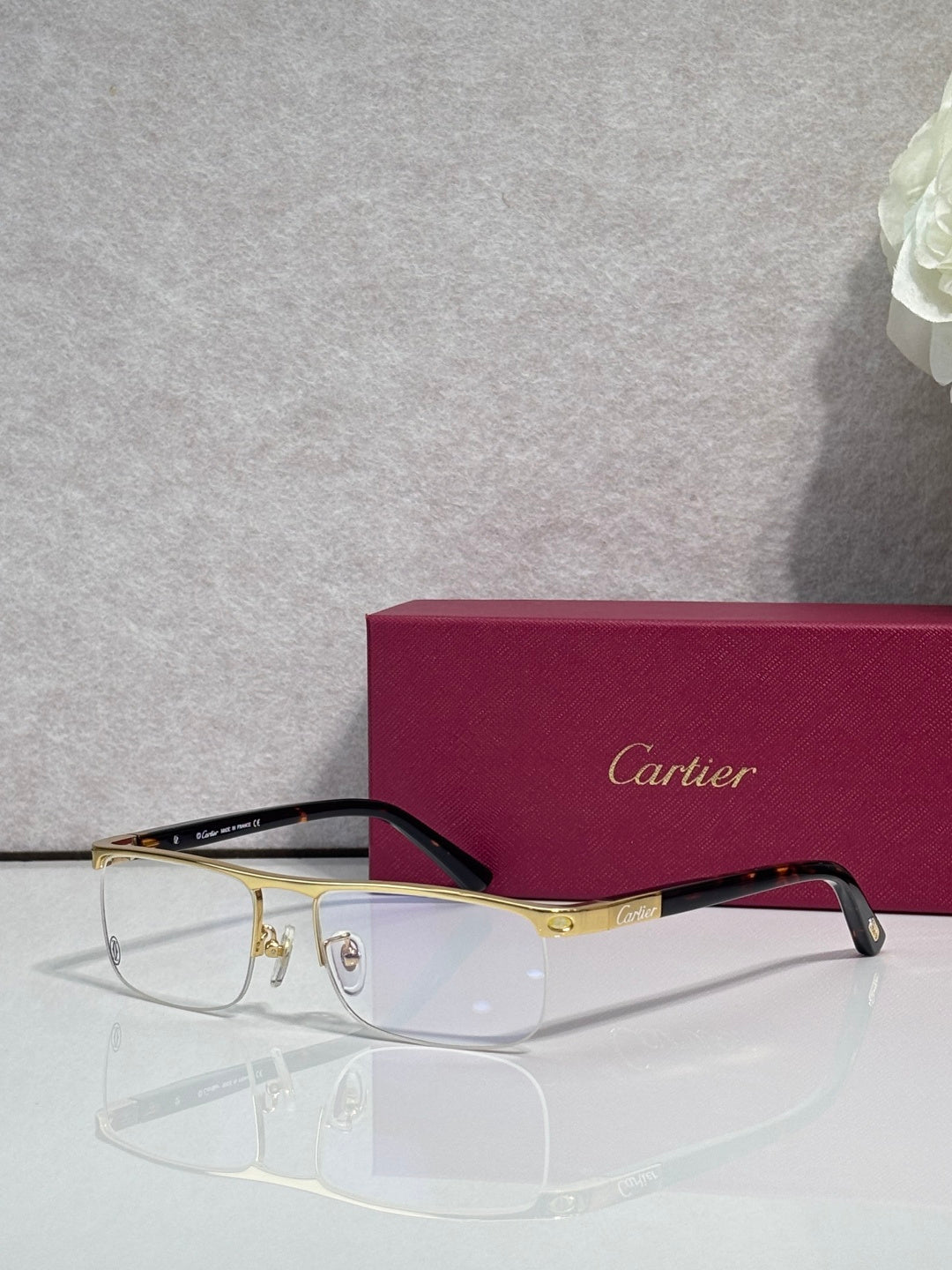 Cartier eyeglasses with dark frame and gold arms, clear lenses