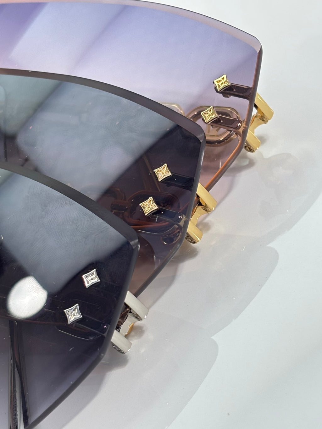 Louis Vuitton sunglasses top view with dark frame and gold temple emblem accents
