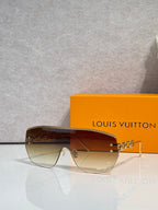 Louis Vuitton sunglasses with amber gradient lenses and brown frame, gold chain detail