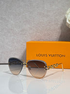 Louis Vuitton sunglasses with dark gradient lenses, gold bridge and chain temple