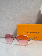 Louis Vuitton sunglasses with pink-to-amber tinted lenses, gold frame and chain temples