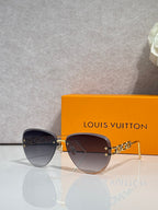 Louis Vuitton sunglasses with brown gradient lenses, gold frame and chain temples