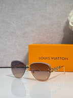 Louis Vuitton sunglasses with amber gradient lenses, gold frame and chain temples