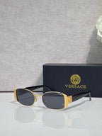 Versace glasses with gold frame, dark lenses, and black temples