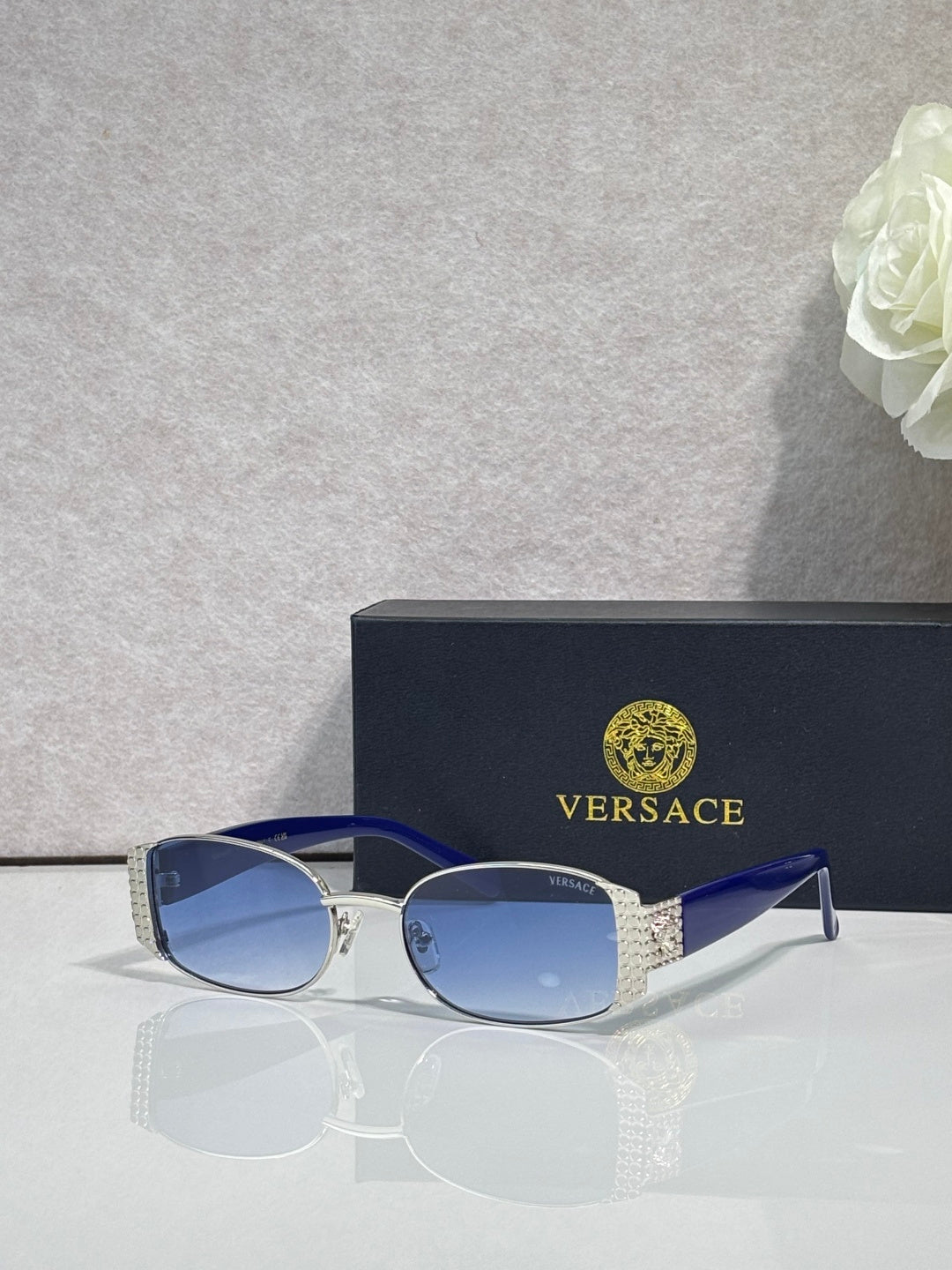 Versace glasses with silver frame, blue tinted lenses, and blue temples