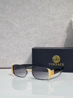 Versace glasses with black frame and dark lenses, gold patterned side details
