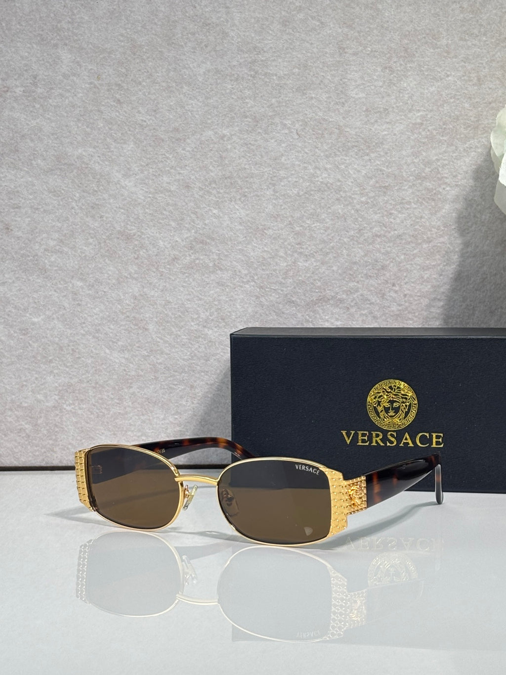 Versace glasses with gold frame, dark brown lenses, and tortoiseshell temples
