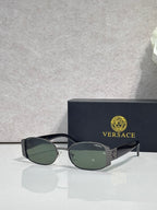 Versace glasses with black frame and green-tinted lenses, black temples